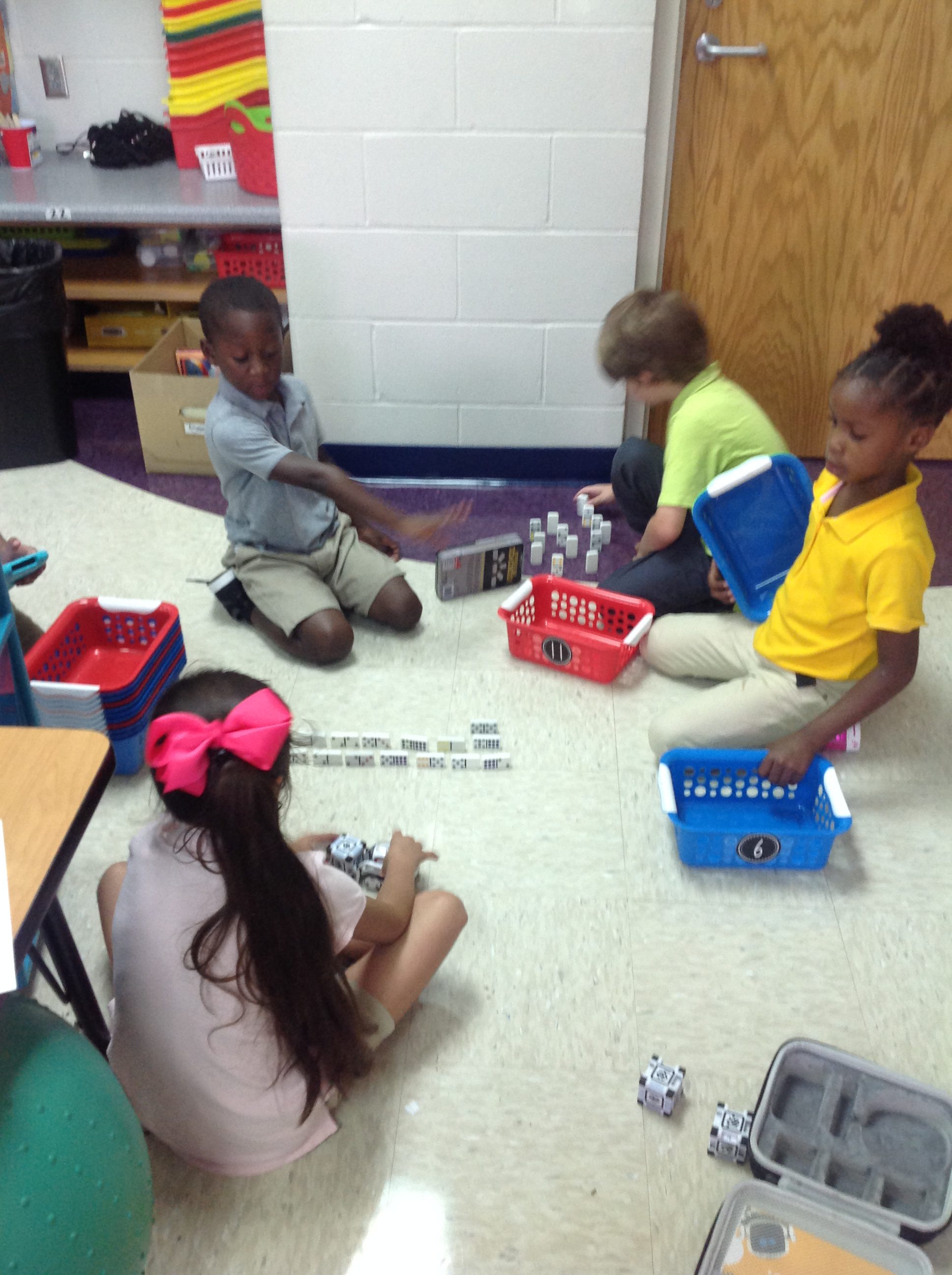 4 first grade students making a maze for a robot