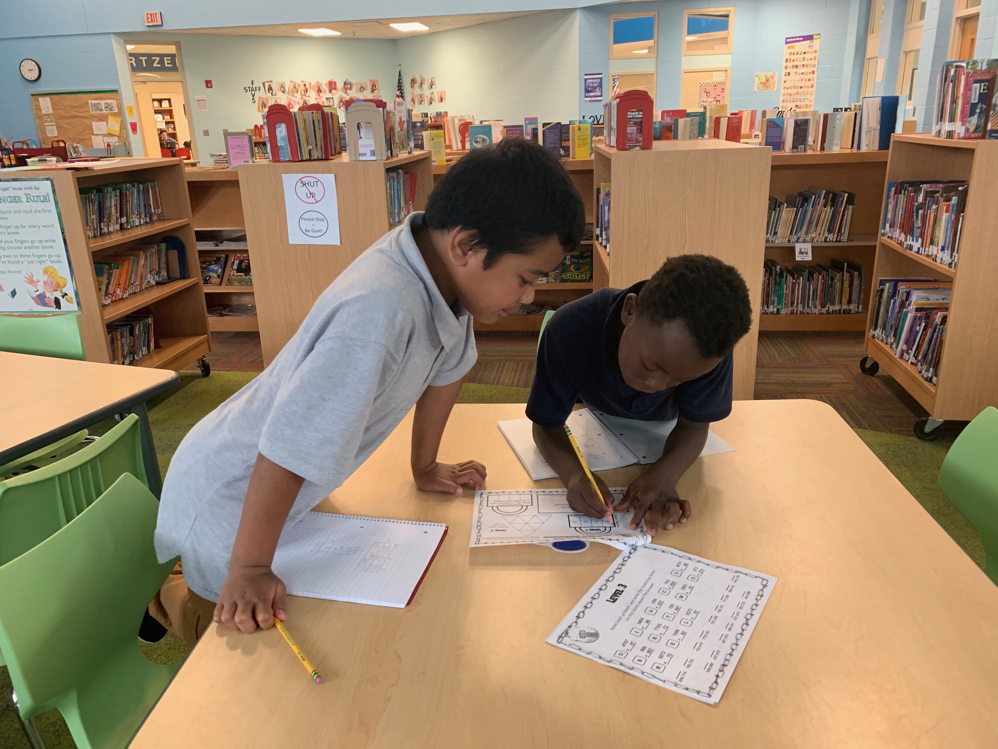 Two students working on a worksheet in the Media Center