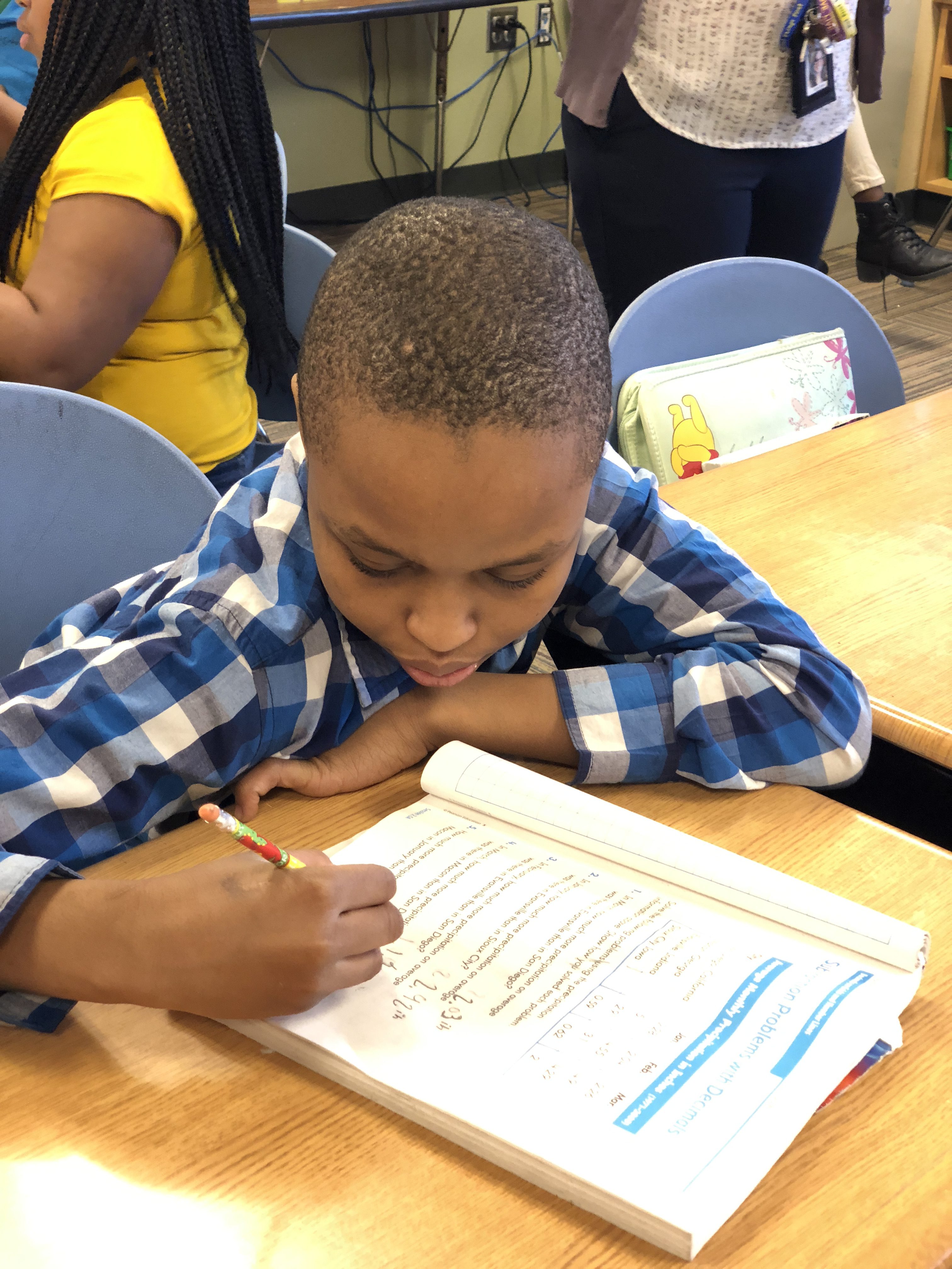student working on math at their desk