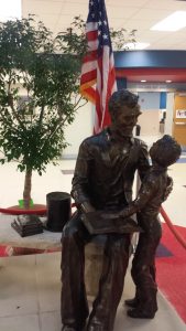 Abe Lincoln and son statue in the entry way of school