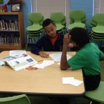 Two elementary boys working together during Media class