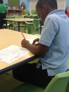 One fourth grade student using a pencil to write down information