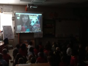 Kindergarten class looking at Molly the Fire Safety do who is on the Promethean Board