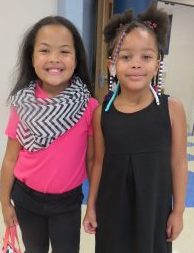 Two girls smiling on the first day of school