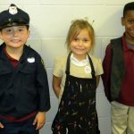 Three children dressed up as workers