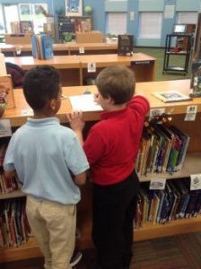 Two students Searching for and scanning QR codes with their iPad