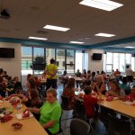 Families eating dinner at tables