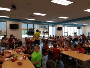 Families eating dinner at tables