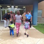 Greeters high fiving an incoming family